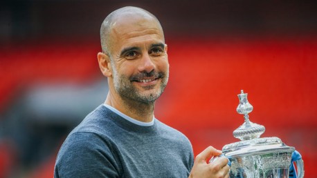 GUARDIOLA GRIN: Pep gets his hands on the cup