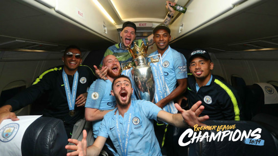 SOAR POINT: The City players celebrate their title success on the flight home from Brighton