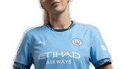 A female individual wearing the Manchester City 2023/24 Puma home kit with Etihad Airways as the sponsor.