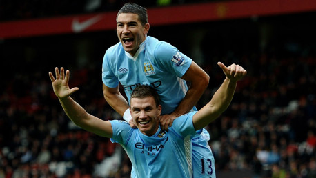 SIX APPEAL: Edin Dzeko celebrates after sealing City's remarkable 6-1 demolition derby win at Old Trafford in October 2011