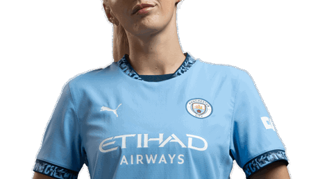 Person in a Manchester City jersey with 'Etihad Airways' sponsor logo and Puma logo visible.
