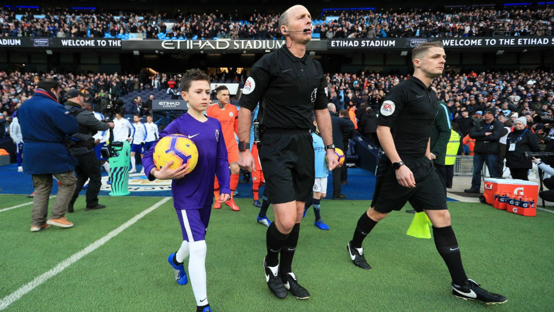 MAGIC MOMENT: Bailey walks out at the Etihad Stadium alongside referee Mike Dean