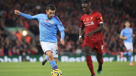 HEAD TO HEAD: Bernardo drives at the Reds' defence after Liverpool took an early lead through Fabinho.